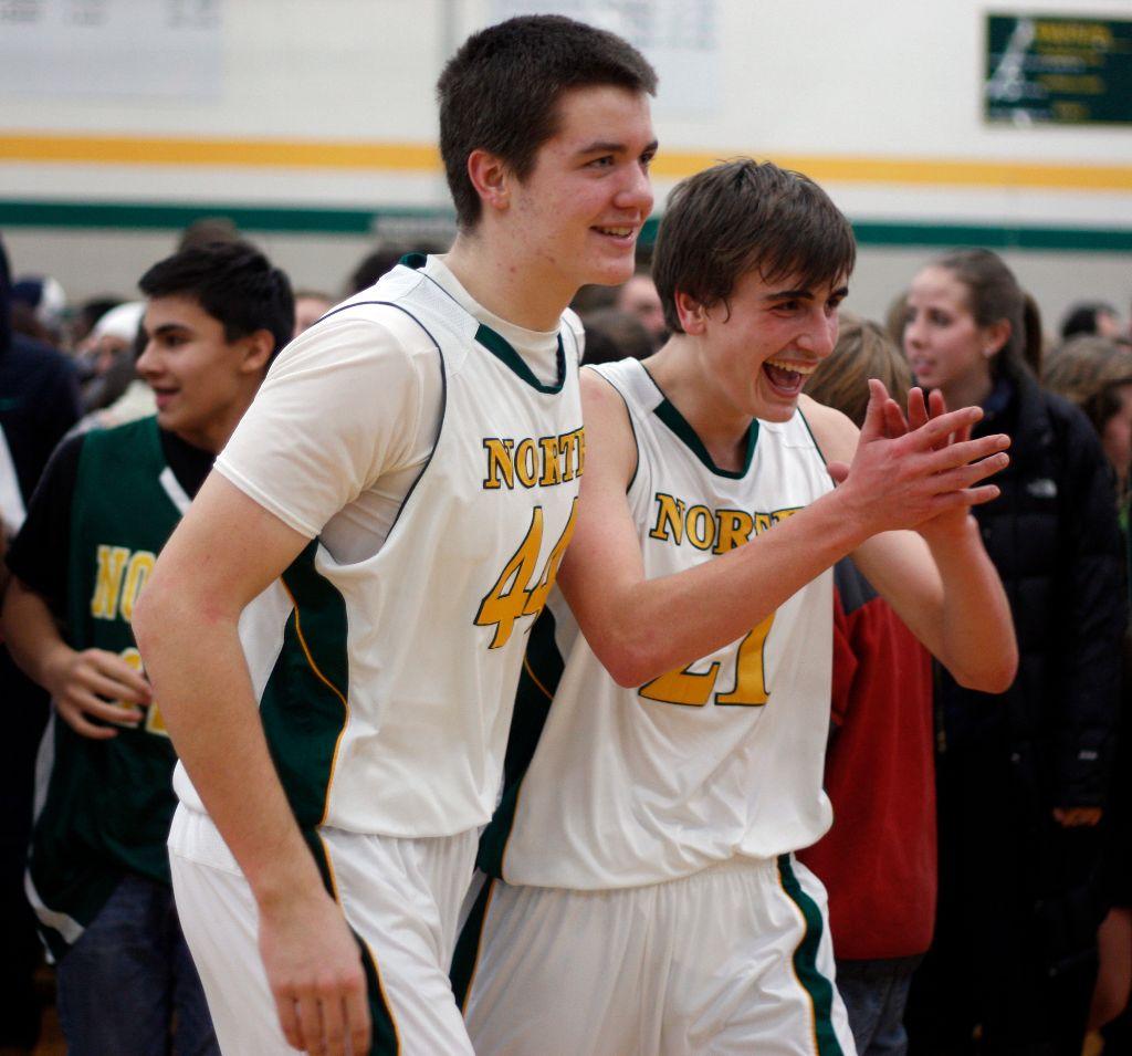 North vs South Varsity Basketball 
Jacob Zacharias (12) and Ryan Reveley (10) celebrate the win after the student sections charged the floor.