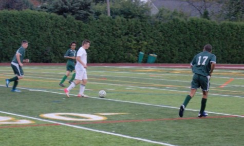 Senior Michael Paret dribbles around players in their first playoff game against East Detroit