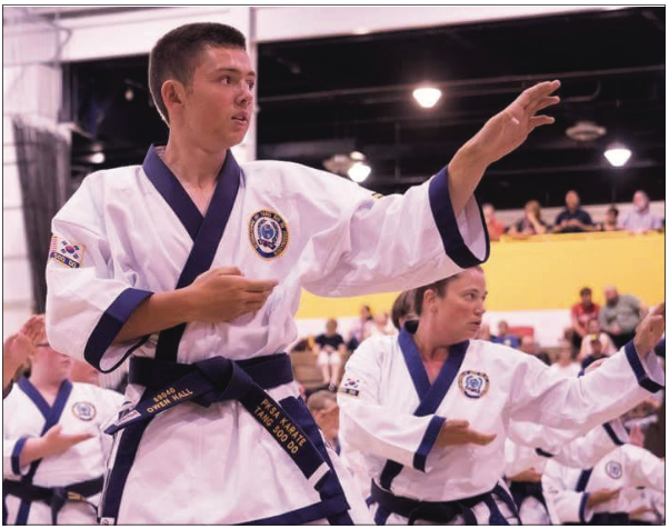 Instructor Owen Hall does a middle knife hand pose.