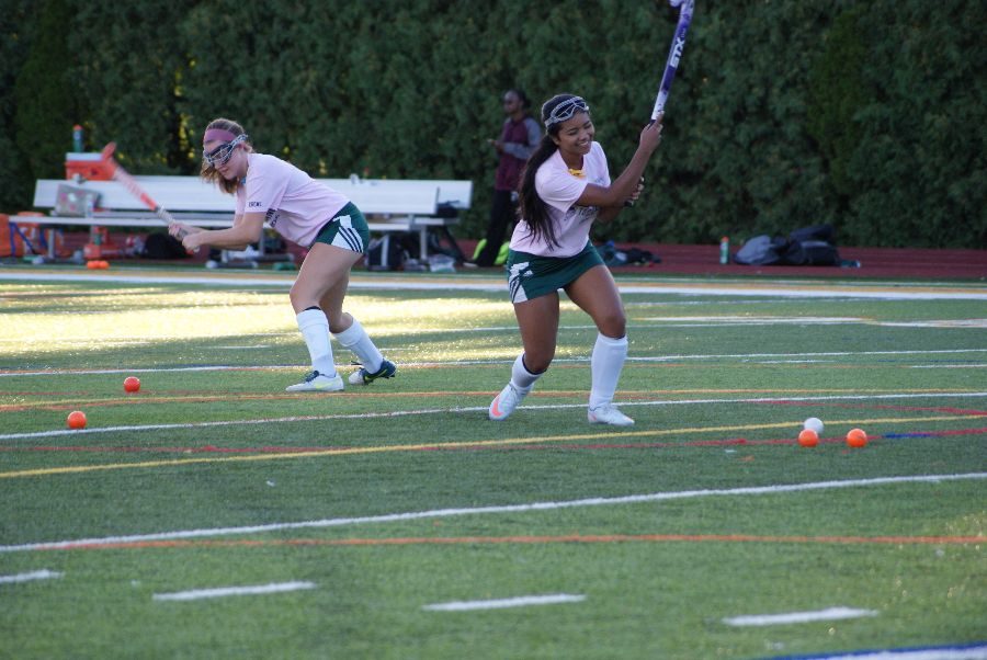 Senior Carmen Castronero (left) and junior Sydney Murray (right) warming up before one of their games. 